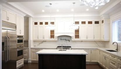 Completed Roomidea traditional kitchen cabinetry with detailed door fronts