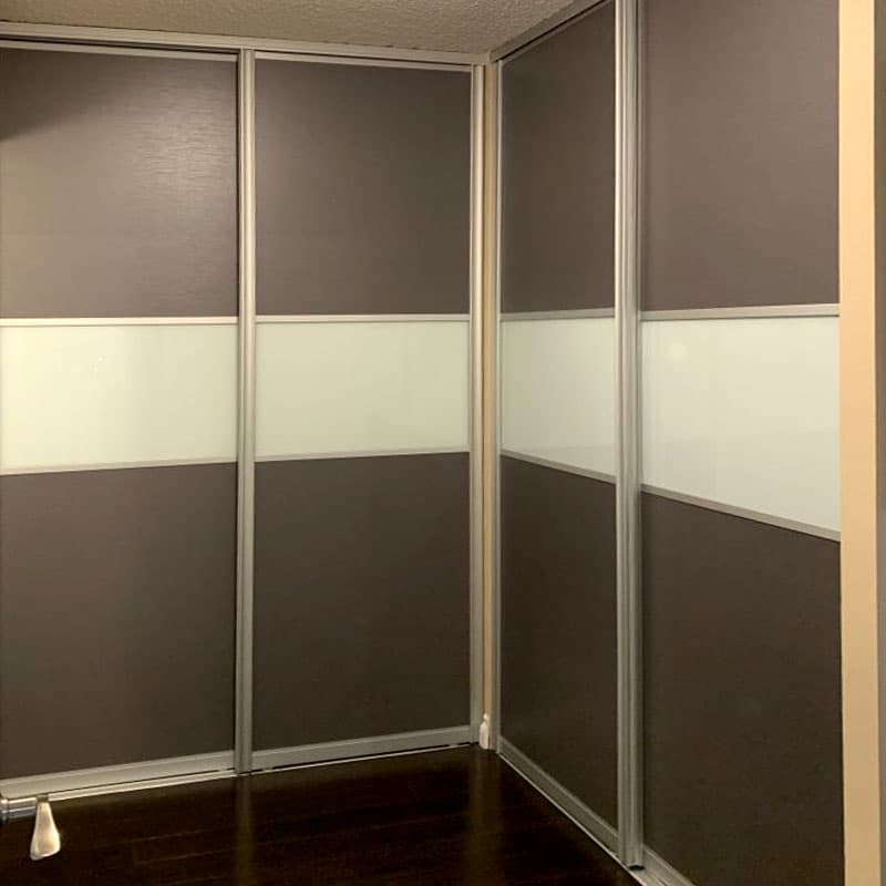 Completed Roomidea corner sliding-door installation with dark wood and light panels