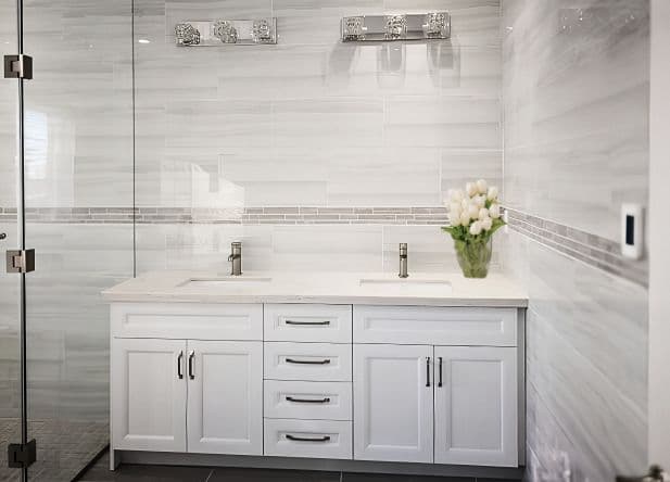 Completed Roomidea bathroom vanity with white drawers, cabinet doors, and a stone countertop