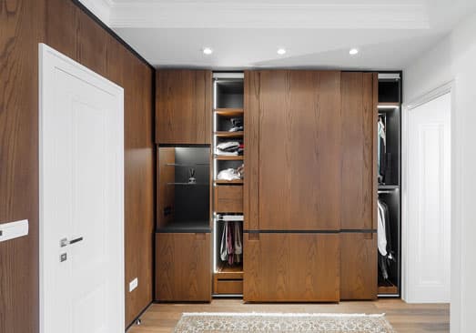 Completed Roomidea whole-home storage wall with full-height wood cabinetry