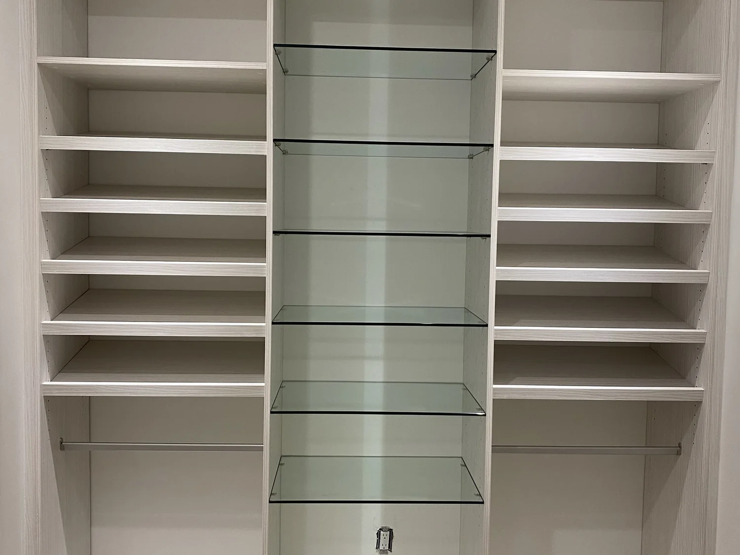 Installed angled shoe shelves with a central glass display section.
