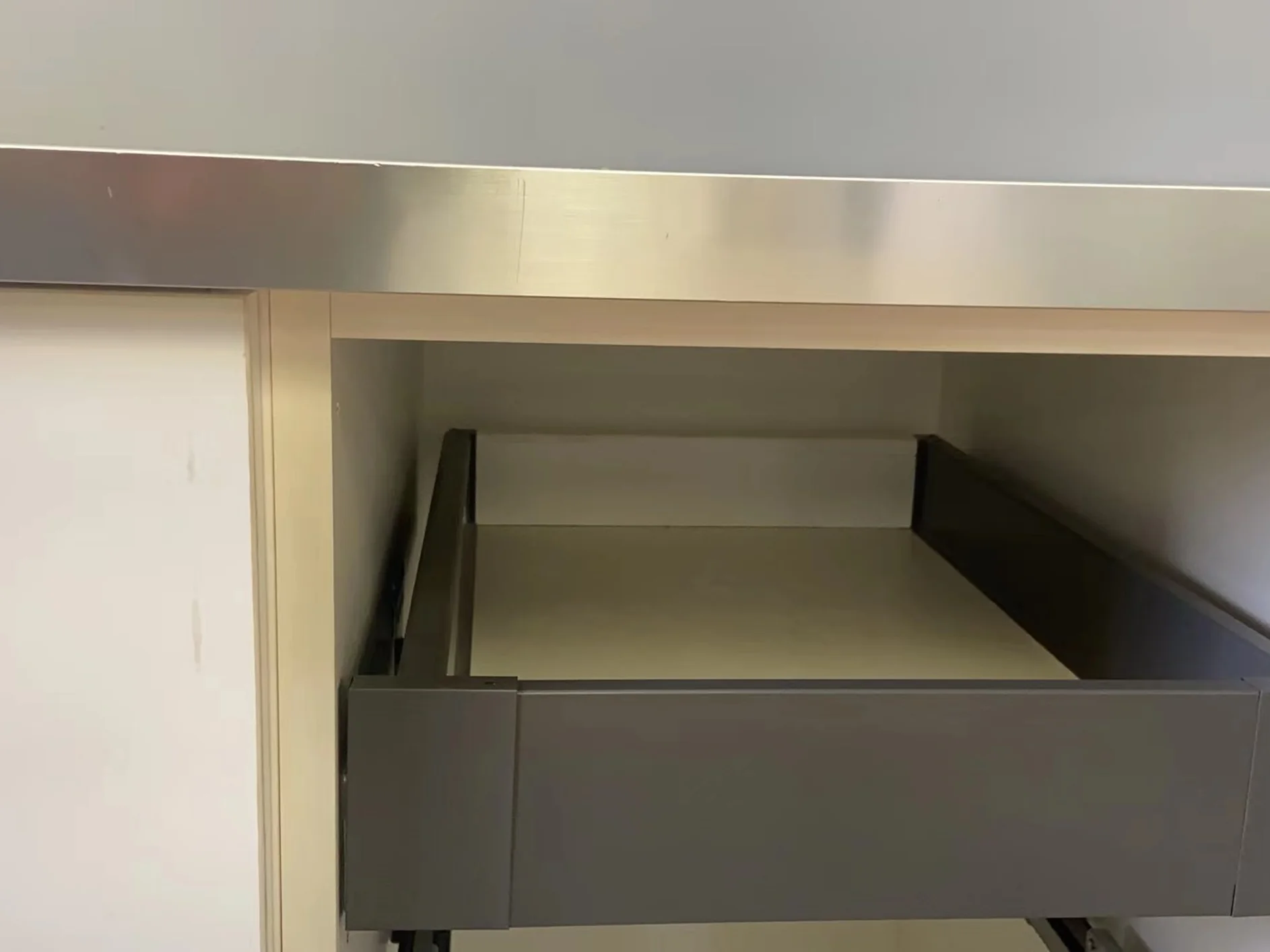 Installed inner drawer providing concealed cabinet storage.