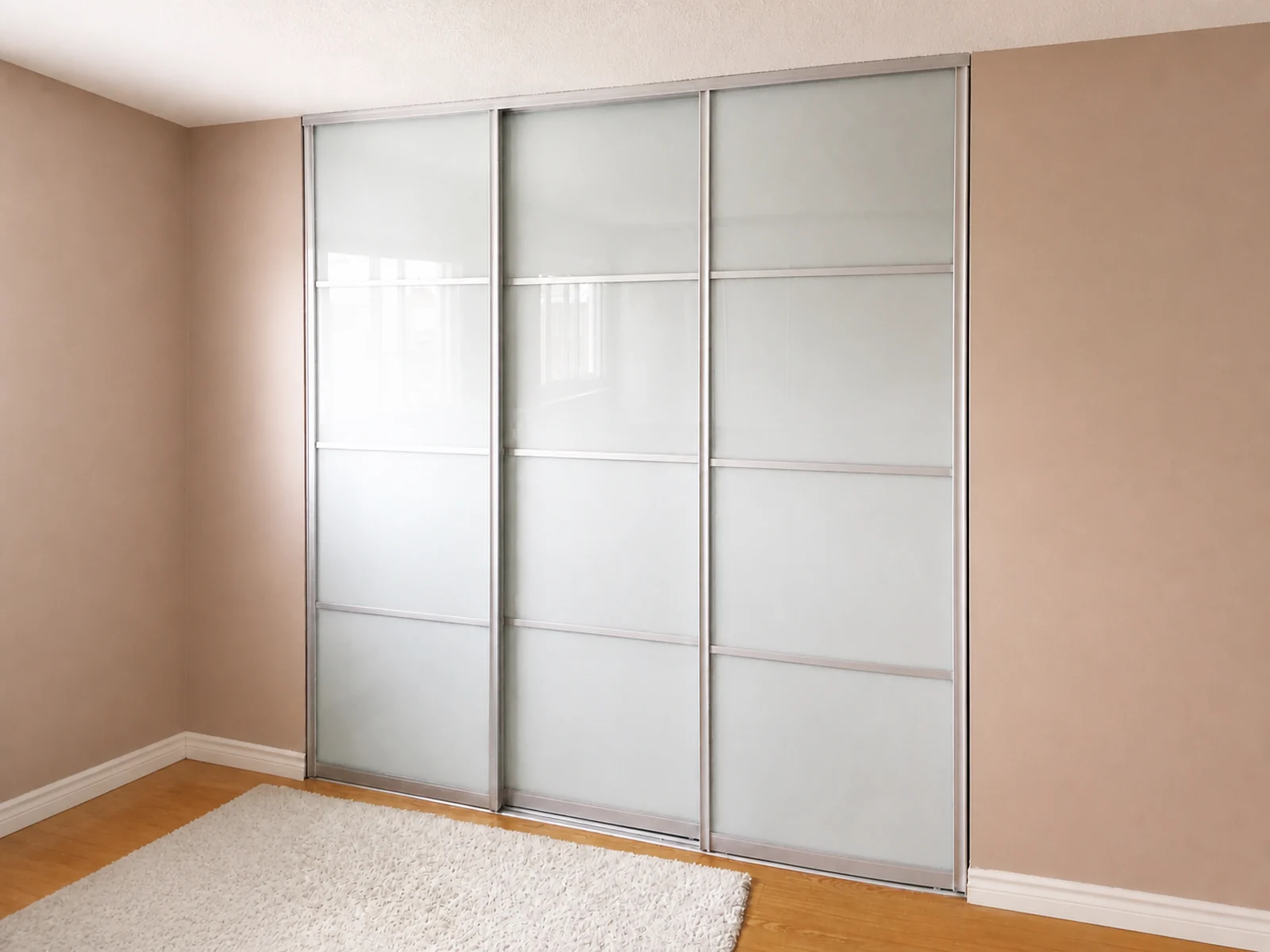 Three frosted glass closet sliding doors installed on a two-track opening.