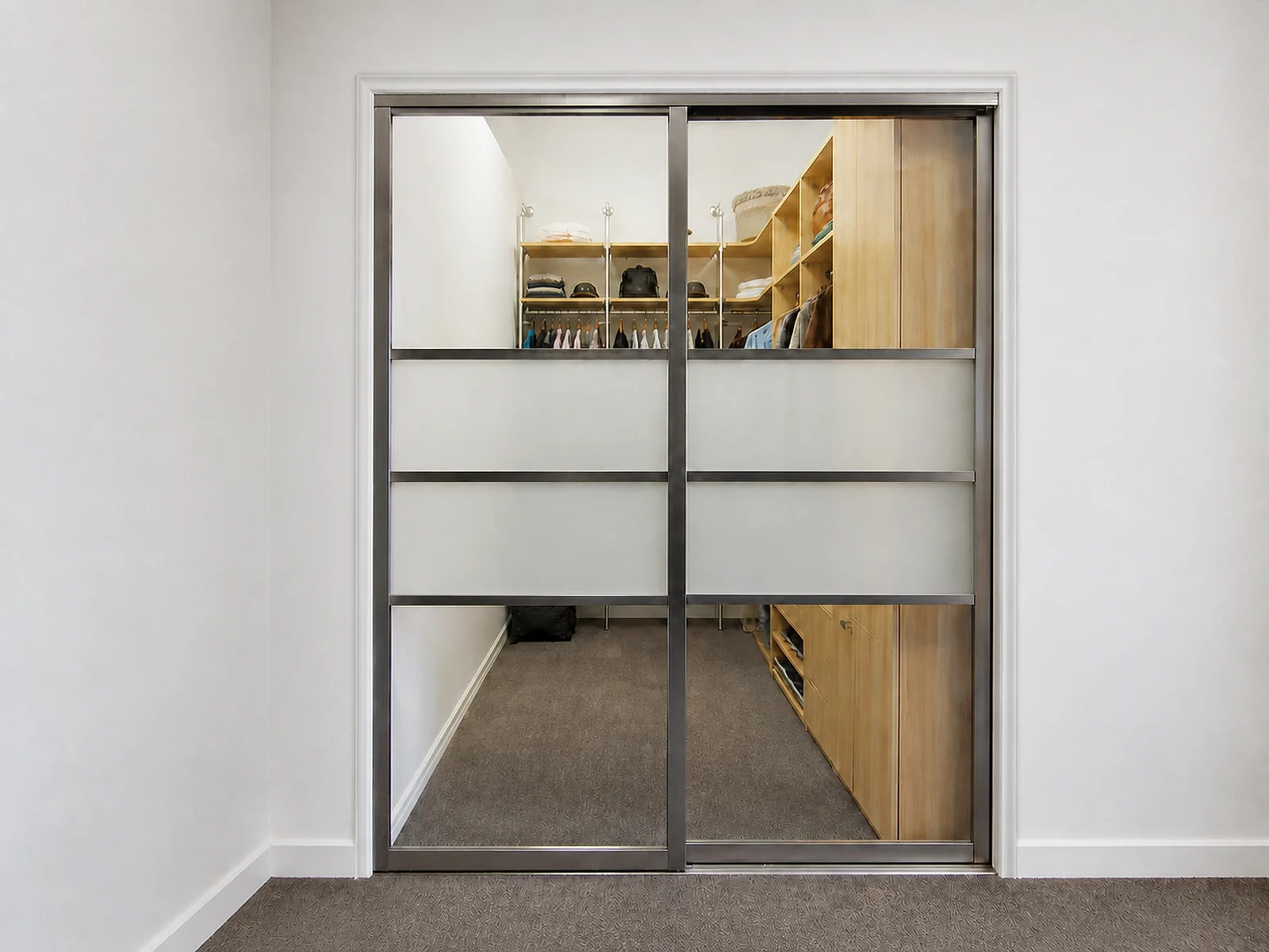 Two-panel sliding glass doors closing a walk-in closet entrance.